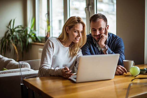 Attractive woman spending time on the internet with her husband.